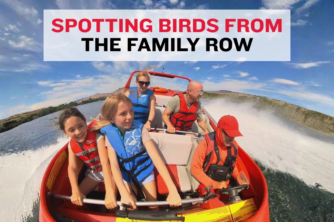 Children pointing toward the shore while seated with parents on a Columbia River boat.
