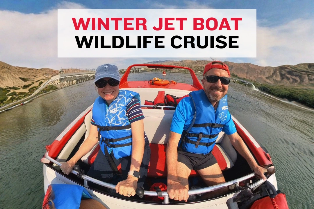 People in winter clothing sitting on a Columbia River boat watching for wildlife